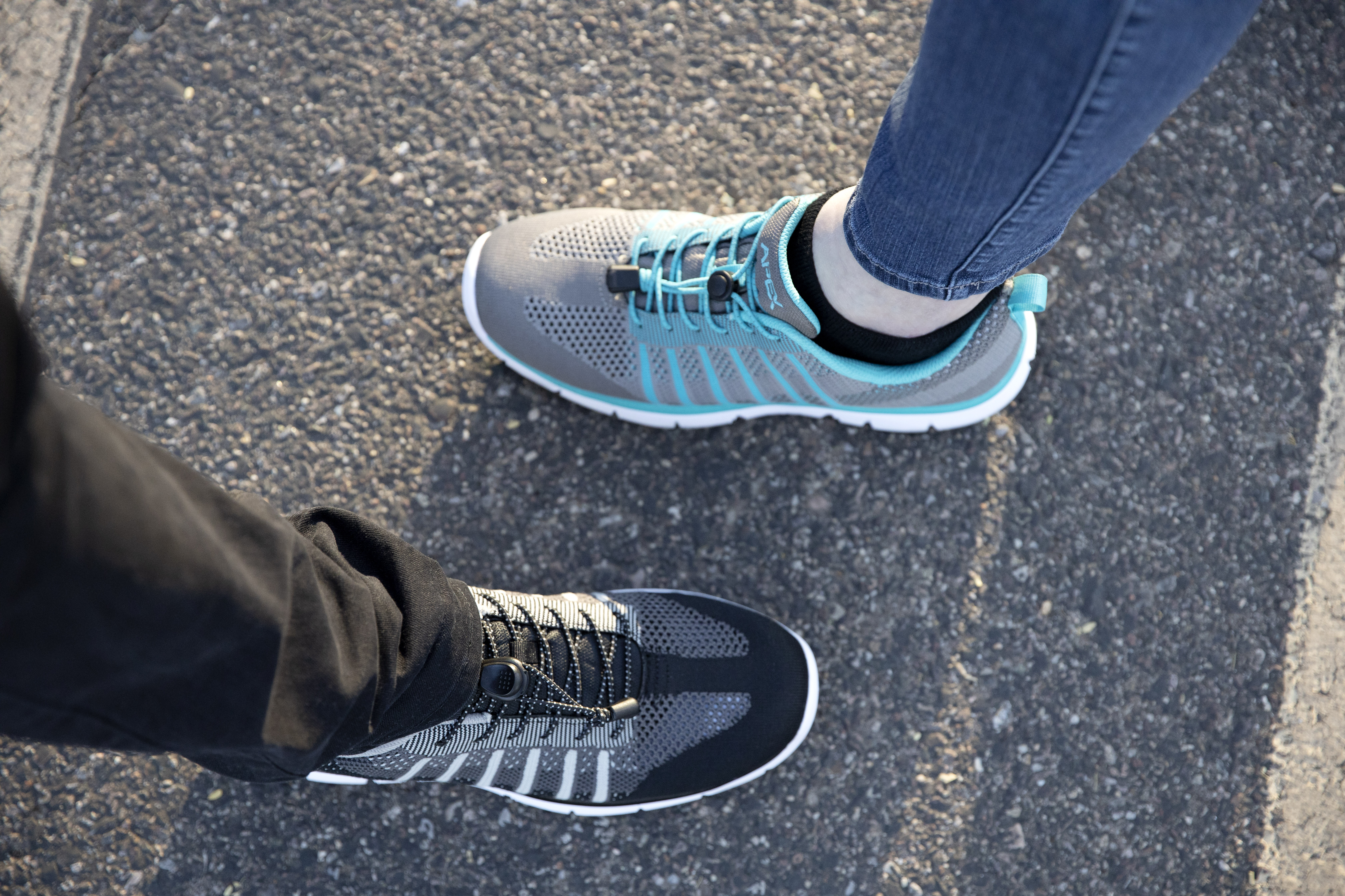 Close up of couple wearing Apex Men's Knit Active Shoe Bolt - Black and Apex Women's Knit Active Shoe Breeze - Grey