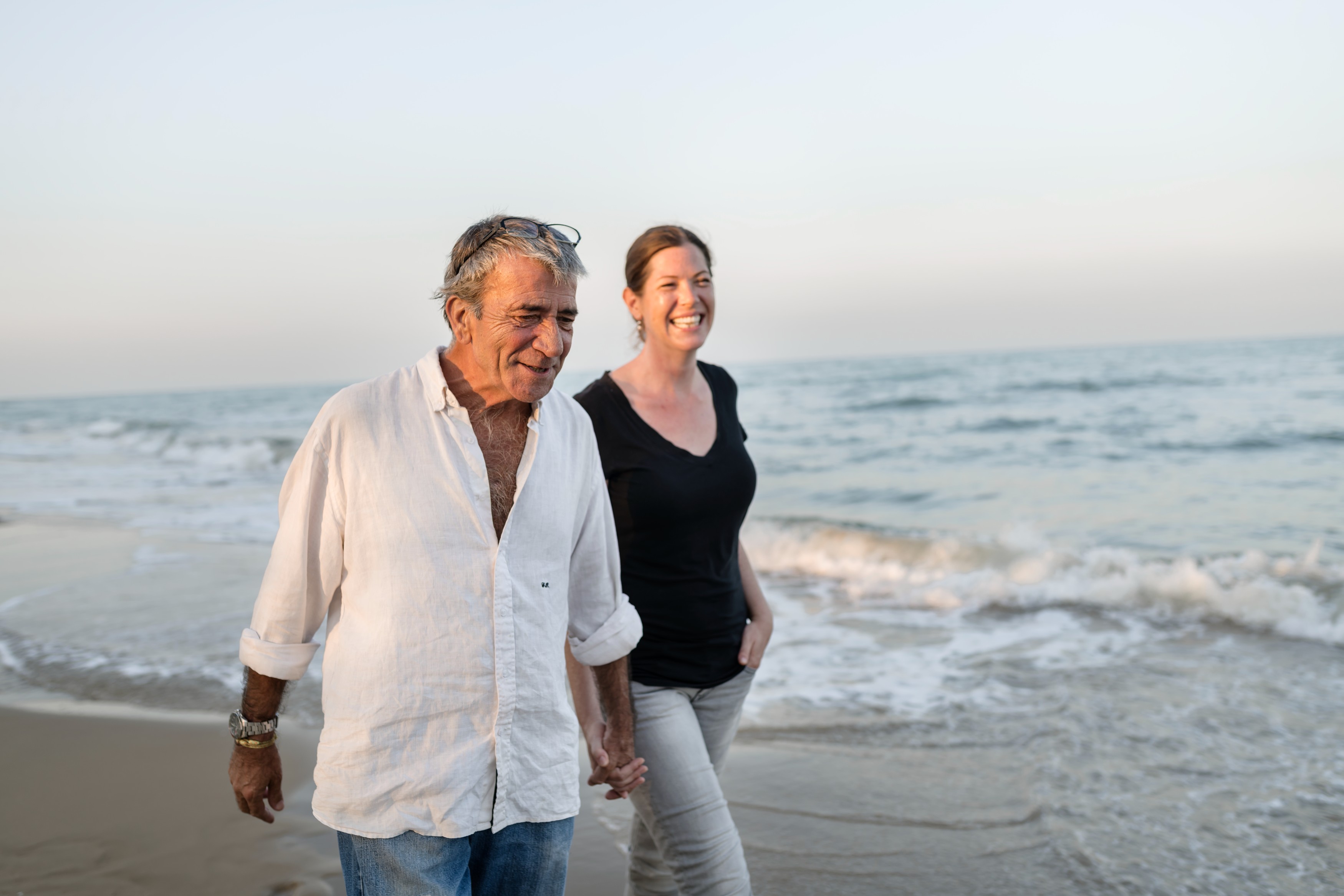 Couple taking morning walk on the beach.