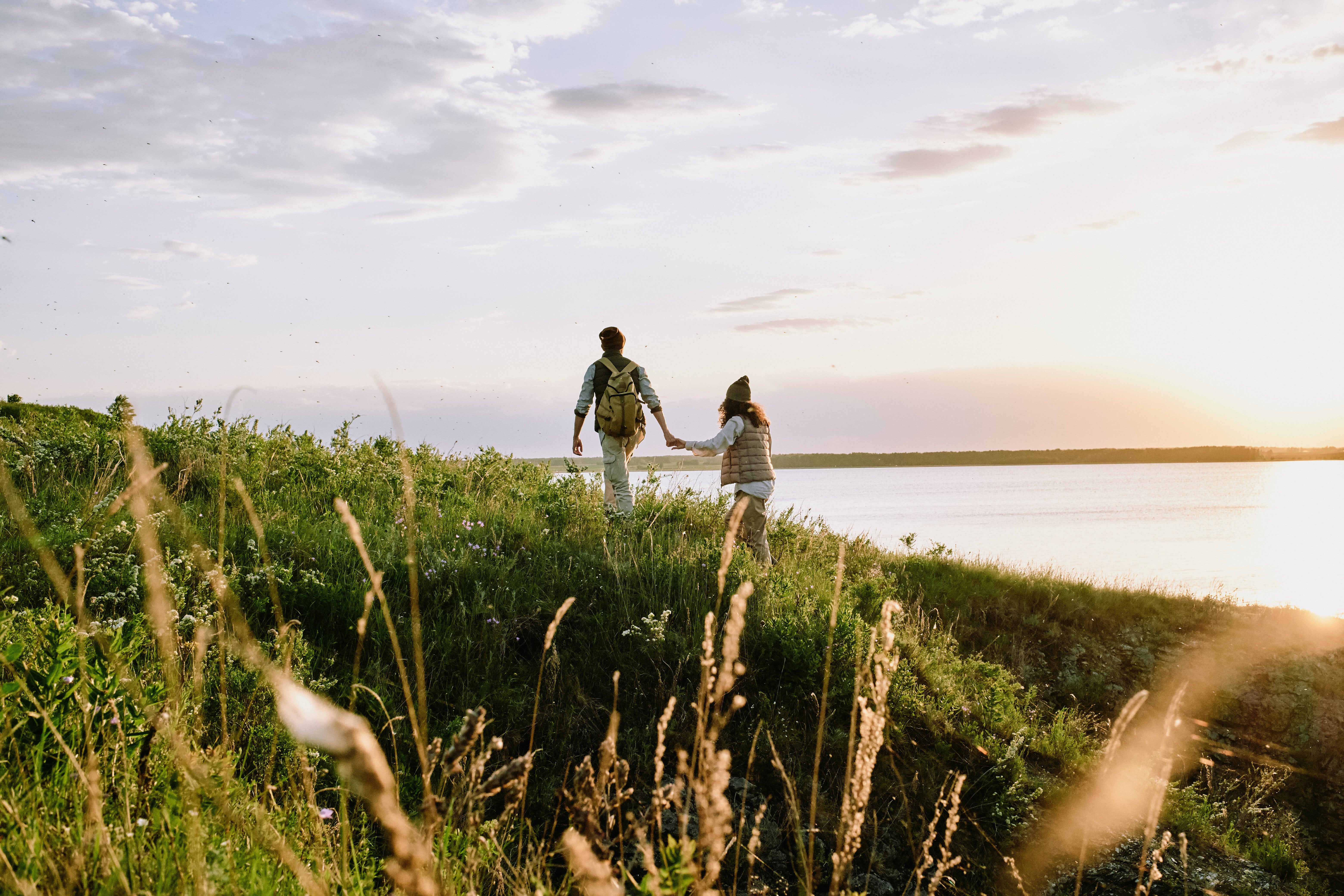 Couple holding hands walking uphill