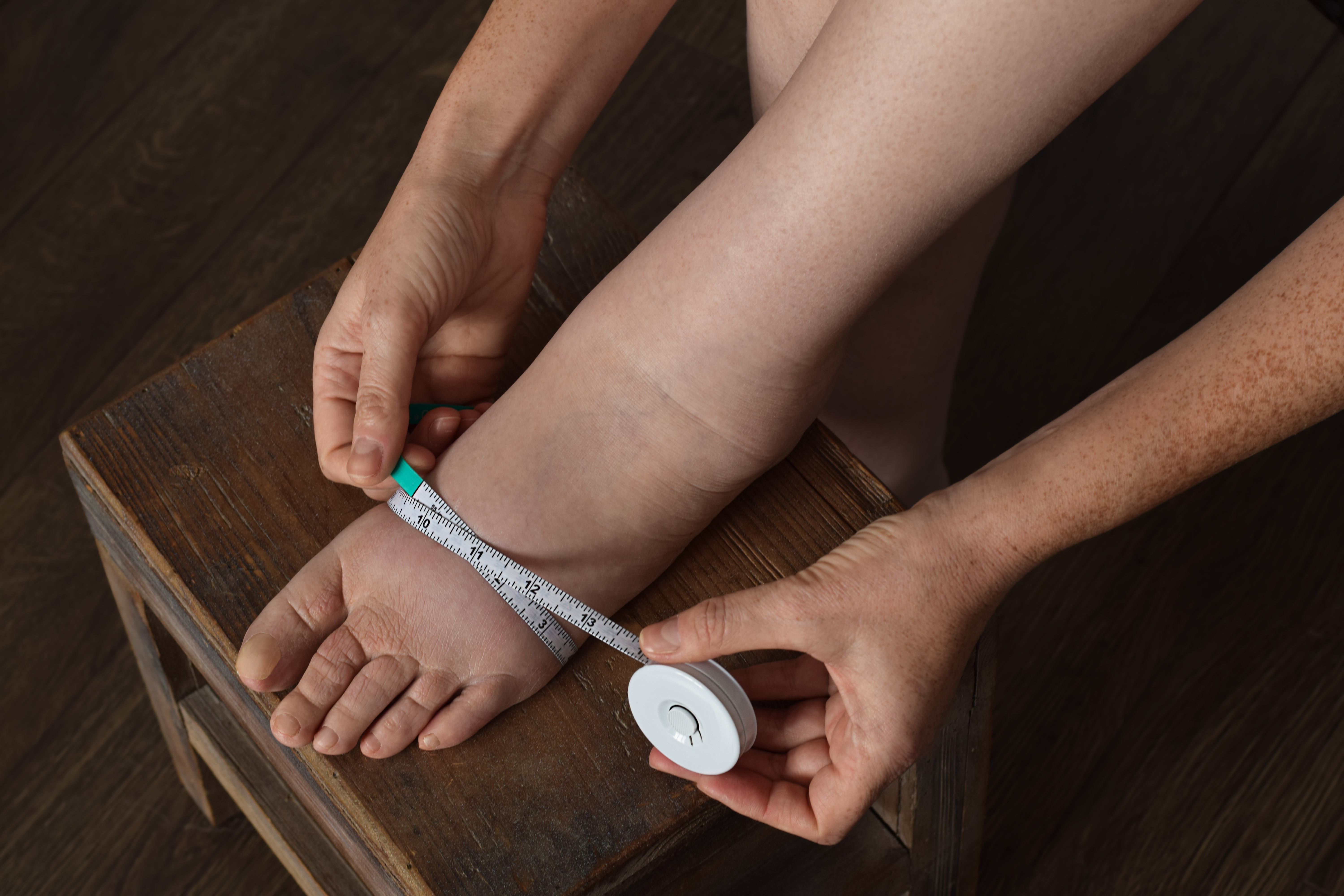 Close up of person measuring foot
