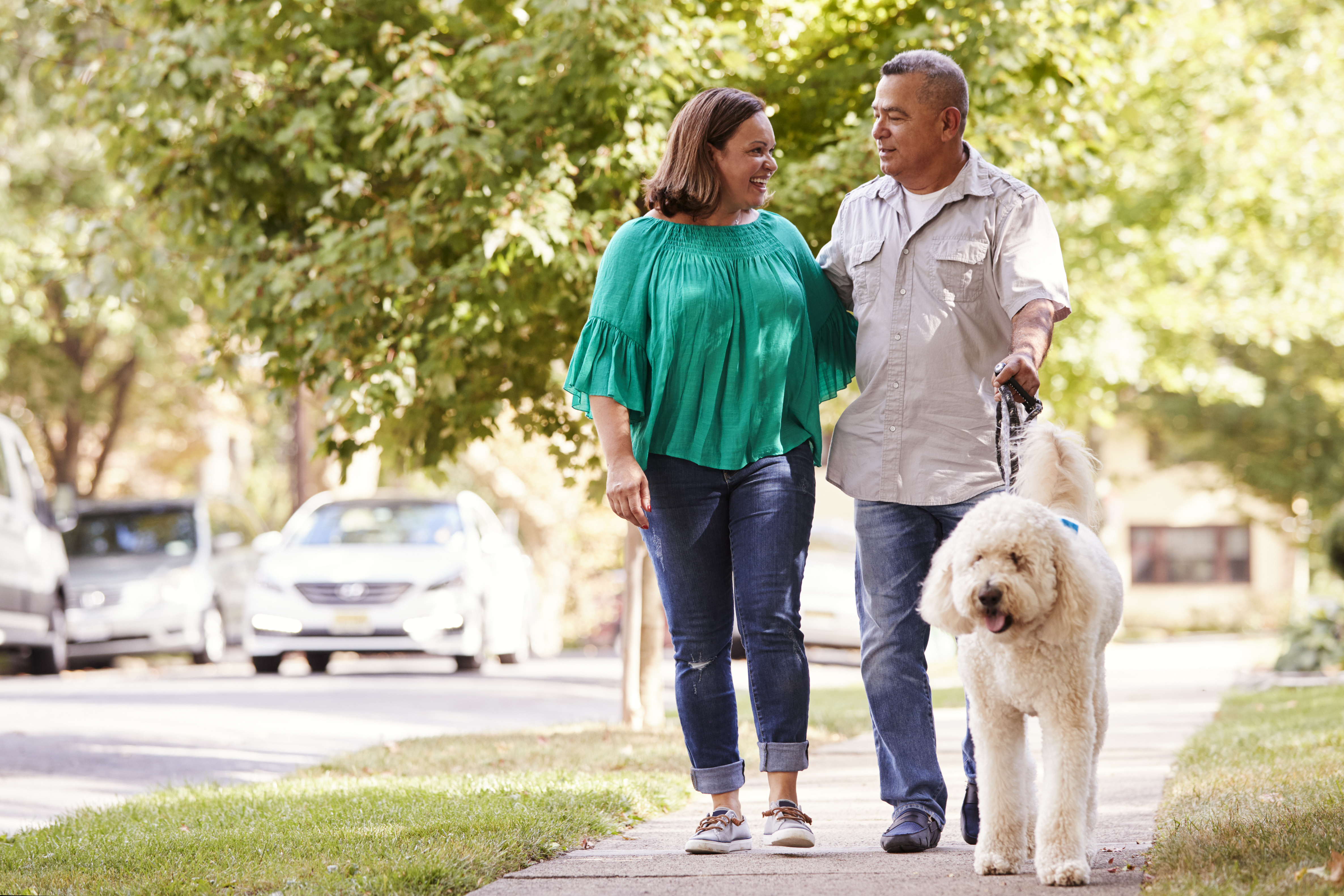Couple walking dog around neighborhood Couple walking dog around neighborhood