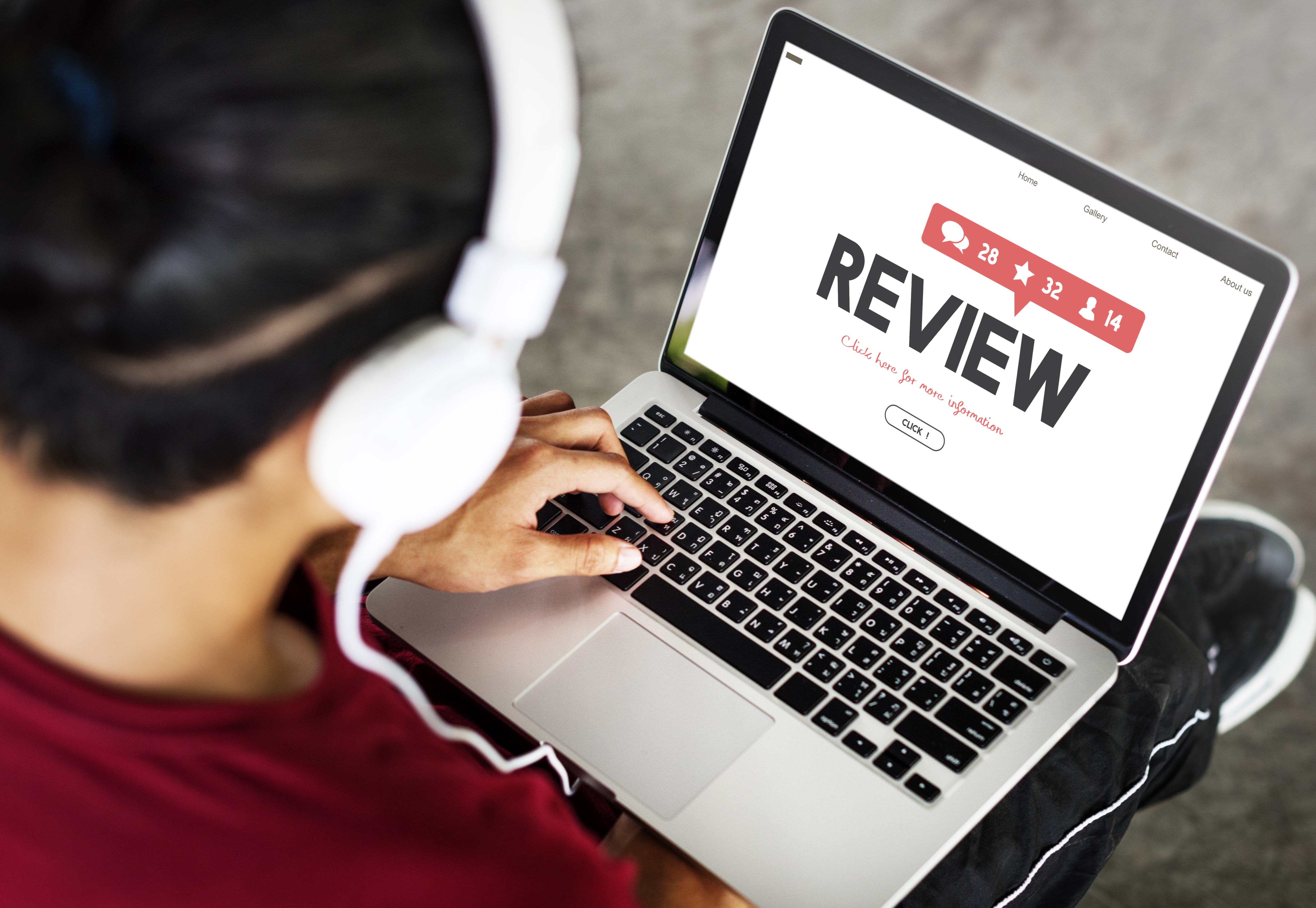 Man looking up reviews on laptop
